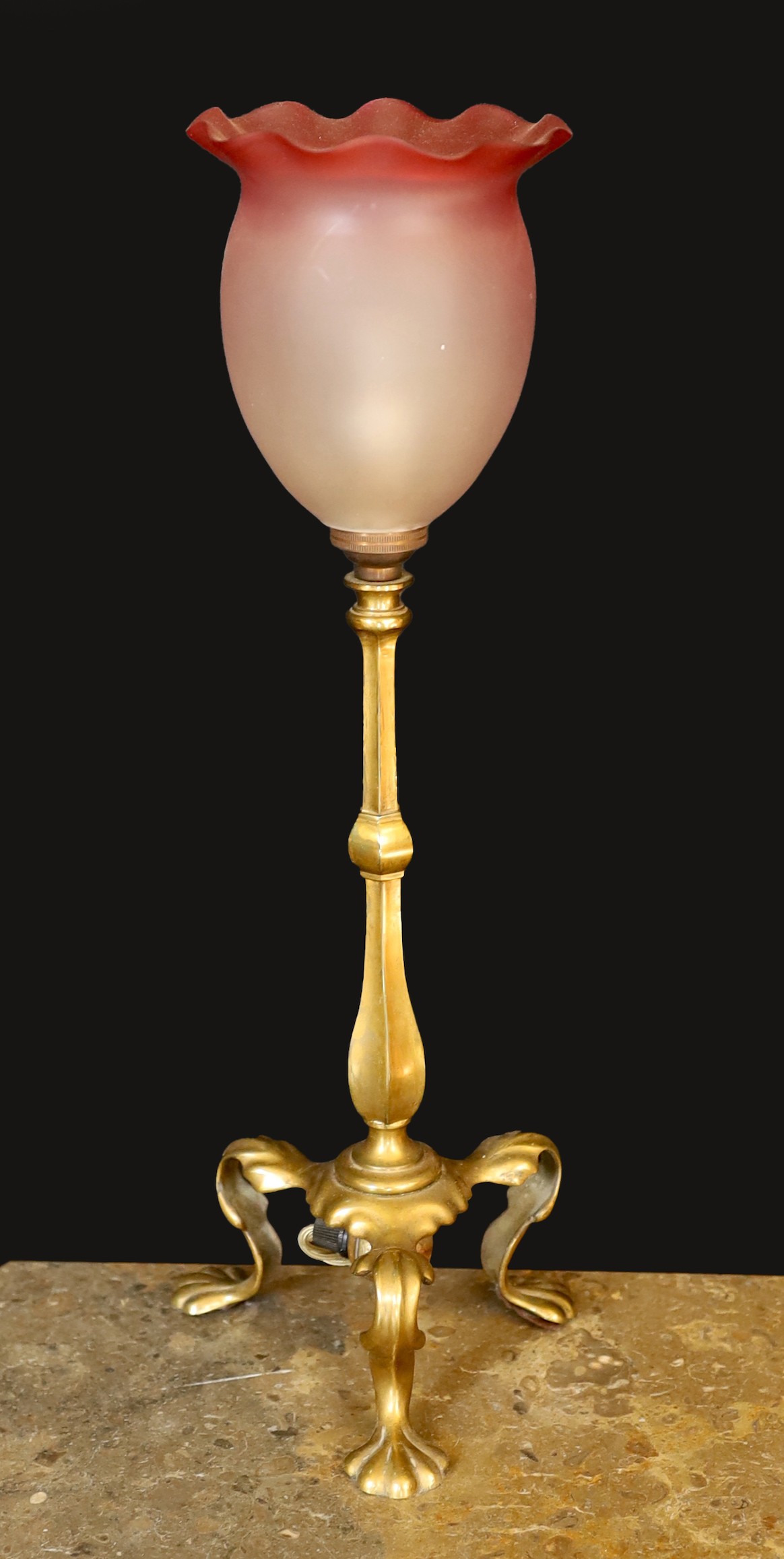 An early 20th century English brass table lamp with associated tinted and frosted glass shade, height overall 44cm
